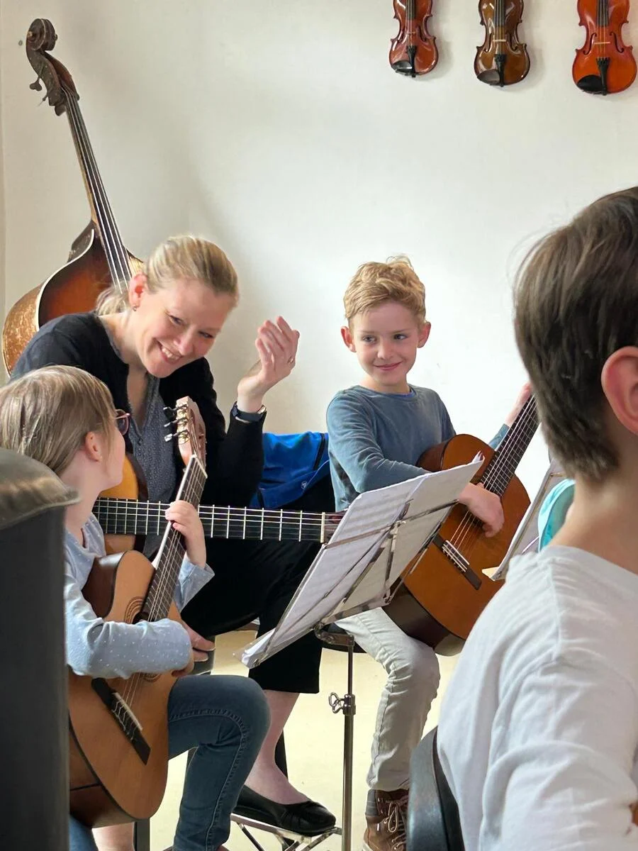 Herz_Lehrerin_mit_Kindern_lachend